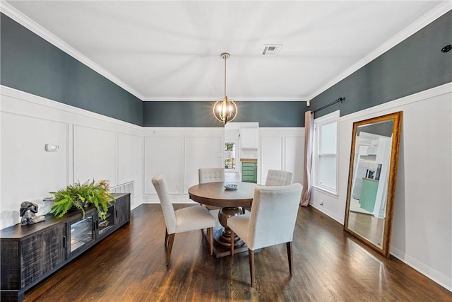 dining room featuring dark hardwood / wood-style floors and crown molding