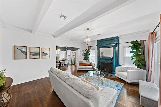 living room with beam ceiling and dark hardwood / wood-style floors