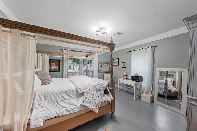 bedroom featuring crown molding and a textured ceiling