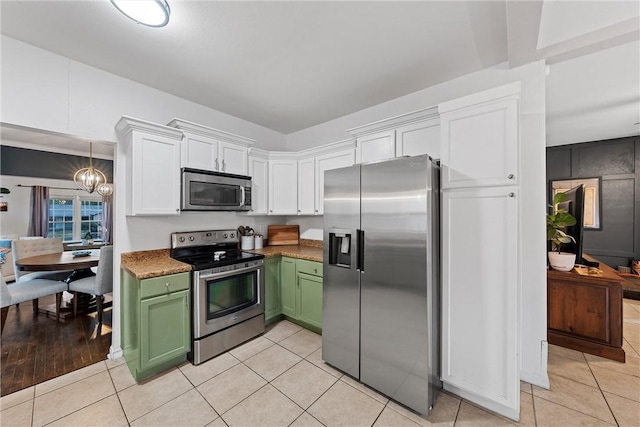 kitchen featuring stainless steel appliances, a notable chandelier, green cabinetry, white cabinets, and light wood-type flooring