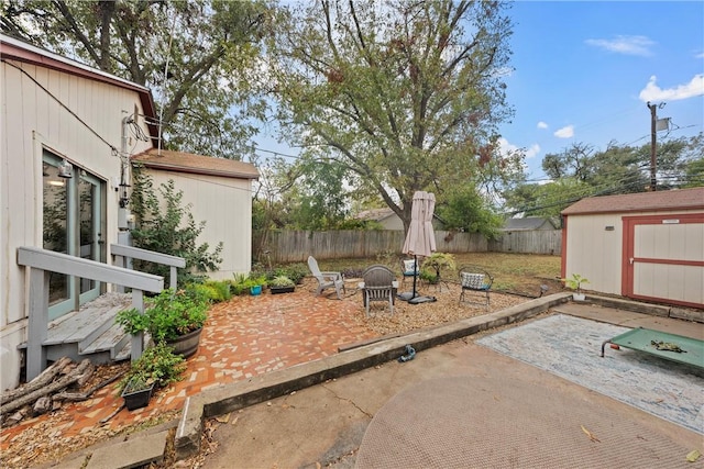 view of patio / terrace with a fire pit and a storage shed