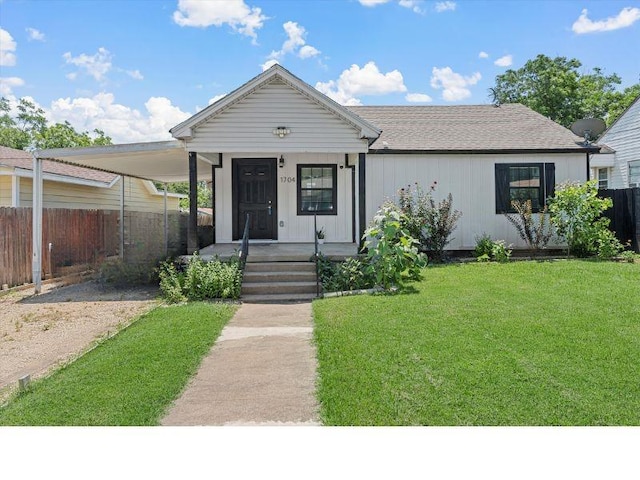 view of front of house with a porch, a carport, and a front lawn