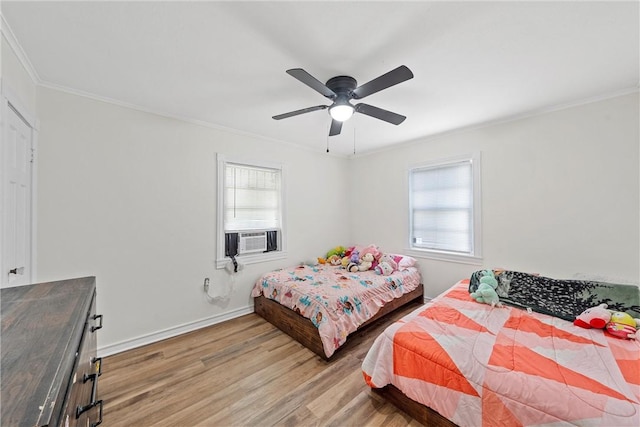 bedroom with hardwood / wood-style flooring, crown molding, and multiple windows