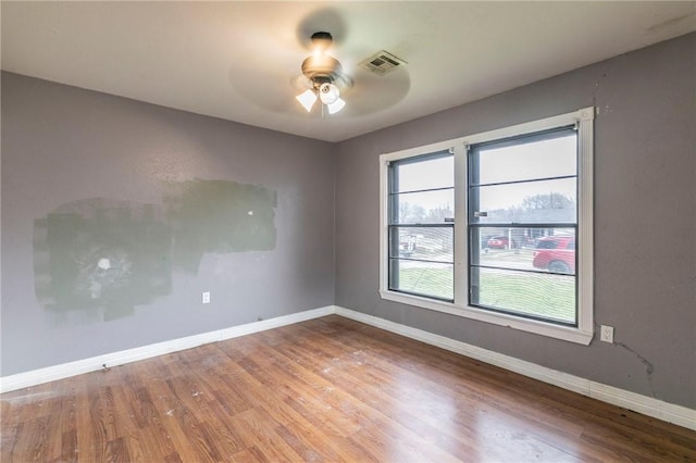 unfurnished room featuring hardwood / wood-style flooring and ceiling fan