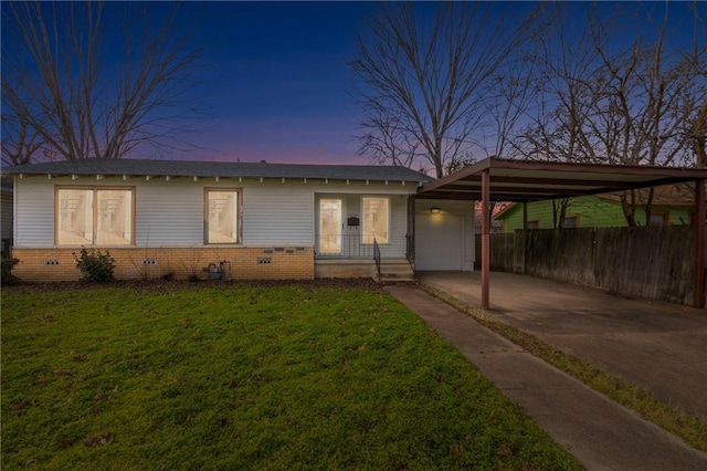 ranch-style house with a carport and a yard