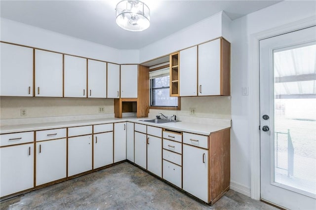 kitchen featuring white cabinetry and sink