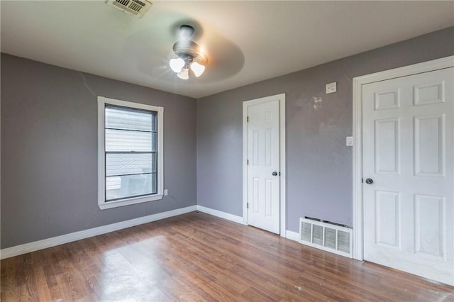 unfurnished room with hardwood / wood-style floors and ceiling fan