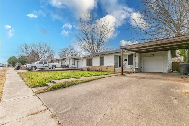 single story home featuring a garage, a front lawn, and a carport