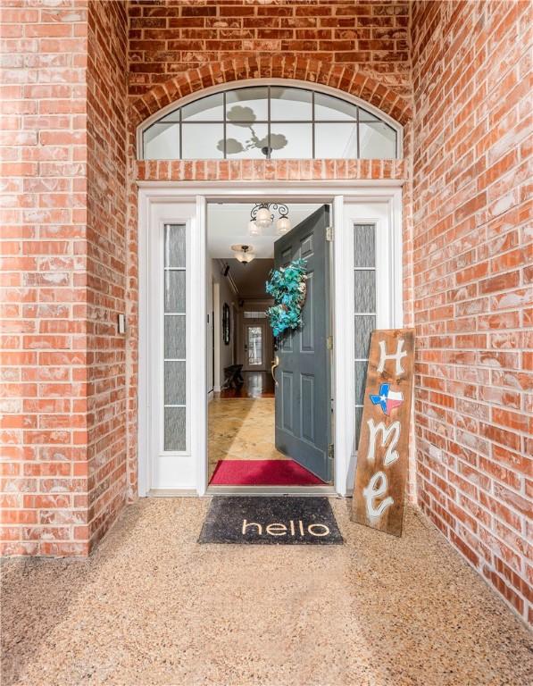 interior space featuring crown molding, light tile patterned floors, and a chandelier