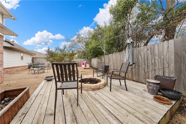 wooden terrace featuring a fire pit