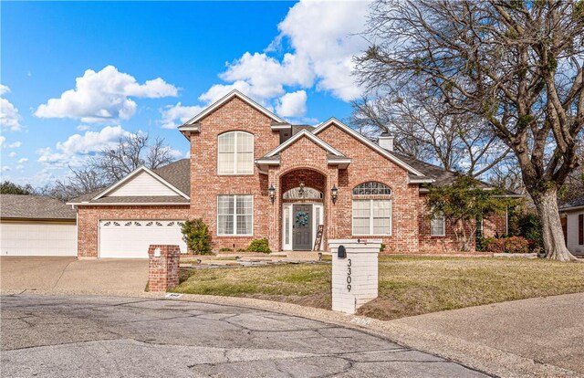 front of property with a garage and a front yard