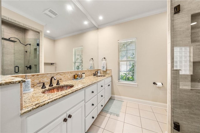 bathroom featuring tile patterned flooring, decorative backsplash, vanity, a shower with shower door, and ornamental molding