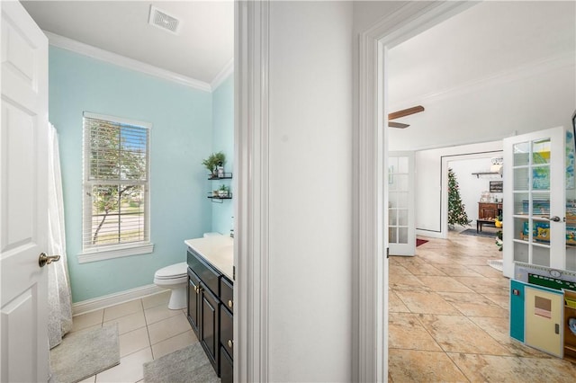 bathroom with vanity, tile patterned flooring, ceiling fan, toilet, and ornamental molding