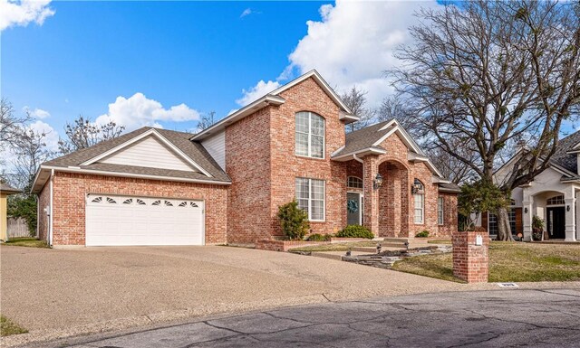 view of front property featuring a garage and a front lawn