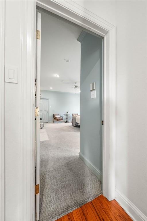 hall with hardwood / wood-style flooring