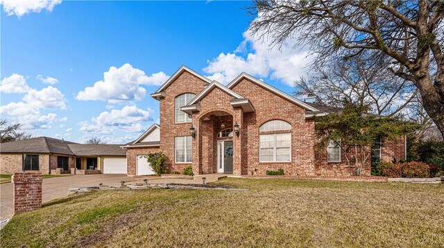 view of front property with a front lawn and a garage