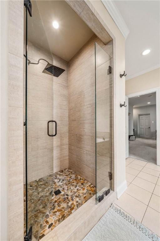 bathroom featuring tile patterned floors, ornamental molding, and walk in shower