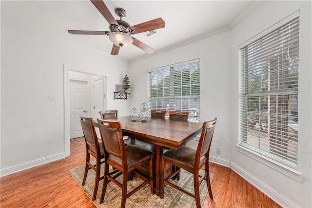 dining room featuring ceiling fan, ornamental molding, and light wood-type flooring