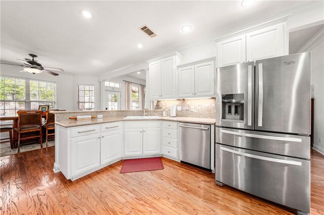 dining room featuring ornamental molding, ceiling fan, and light wood-type flooring