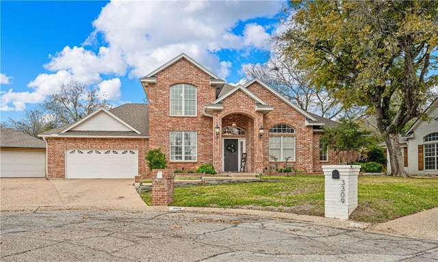 front of property with a front yard and a garage