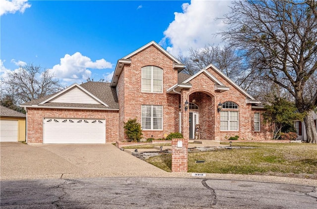 view of property with a garage and a front yard