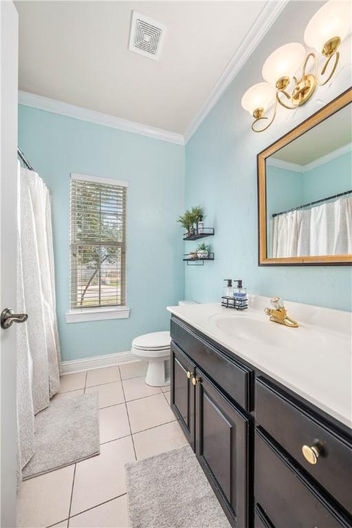 bathroom with tile patterned flooring, vanity, toilet, and crown molding