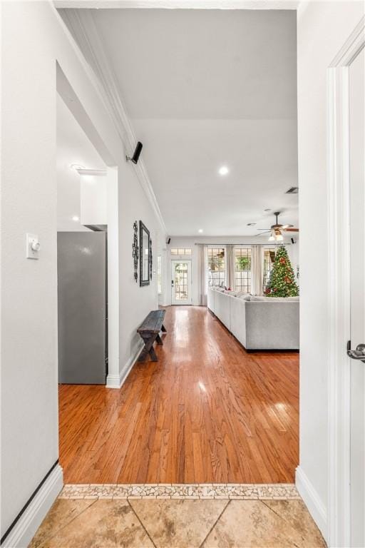 corridor featuring hardwood / wood-style flooring and crown molding