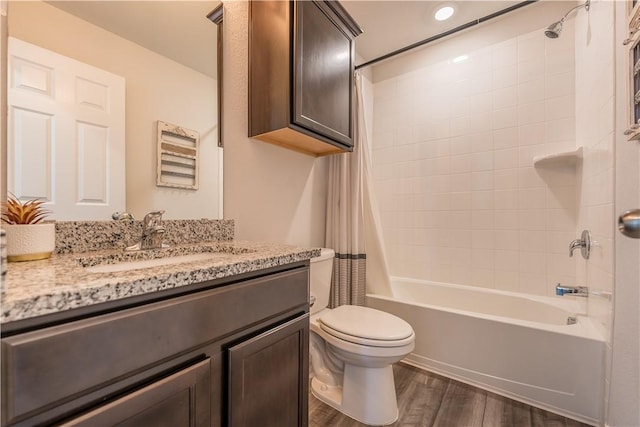 full bathroom featuring shower / bathtub combination with curtain, vanity, and toilet