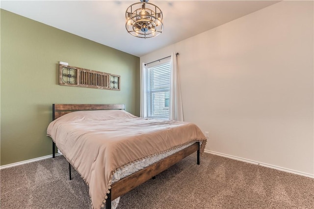 carpeted bedroom with a notable chandelier