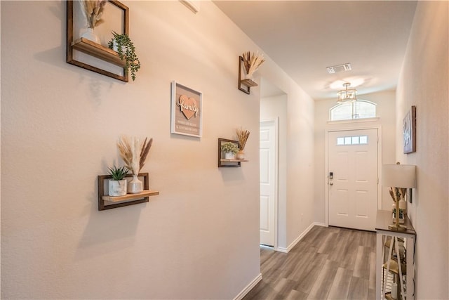 doorway with hardwood / wood-style flooring