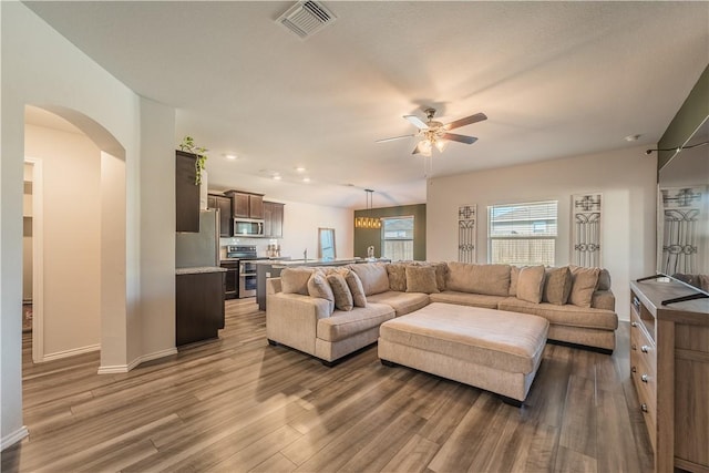 living room with hardwood / wood-style floors and ceiling fan