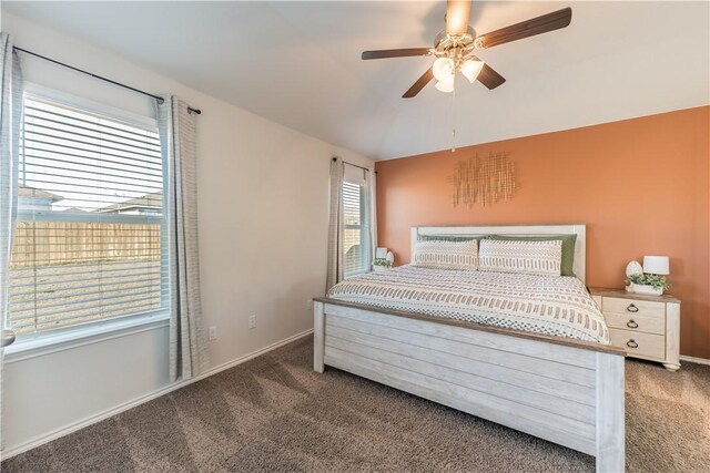 carpeted bedroom featuring ceiling fan and vaulted ceiling