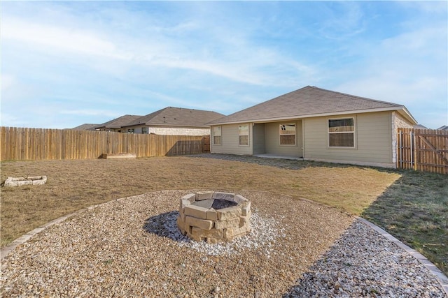 back of house with an outdoor fire pit