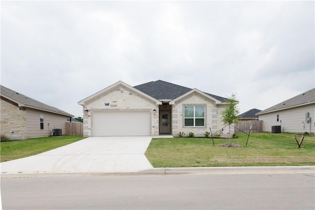 ranch-style home with central AC unit, a front yard, and a garage