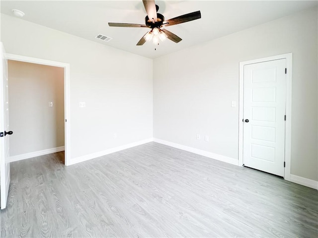 empty room featuring ceiling fan and light wood-type flooring