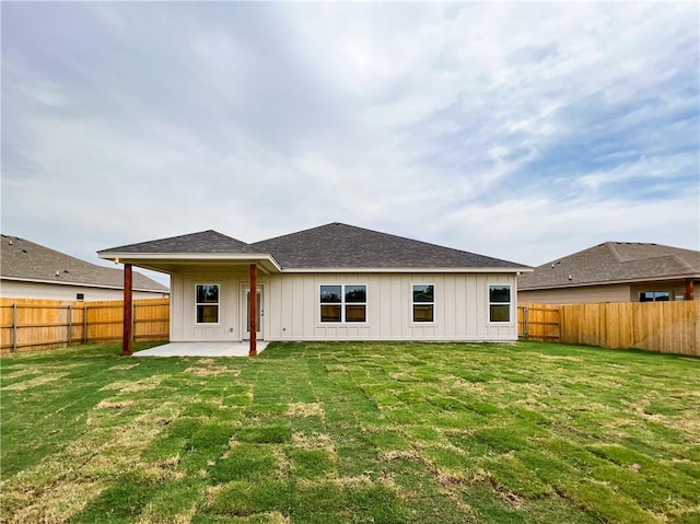 rear view of house with a yard and a patio