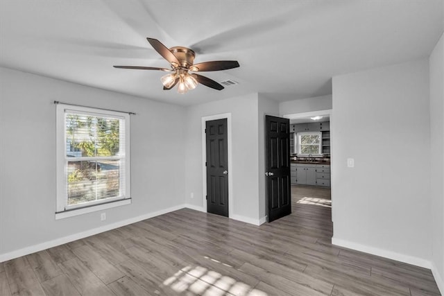 spare room with ceiling fan and light hardwood / wood-style floors