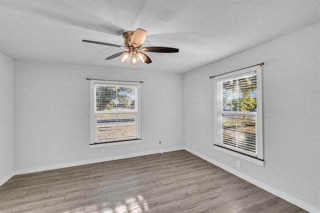 spare room featuring light wood-type flooring and ceiling fan