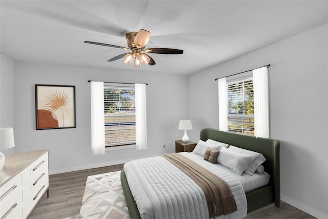 bedroom with light wood-type flooring and ceiling fan