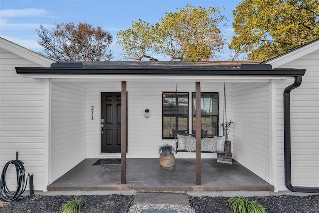 view of exterior entry with covered porch