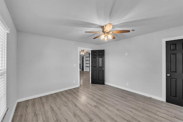 empty room with light hardwood / wood-style flooring and ceiling fan