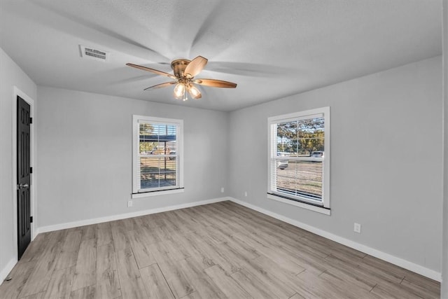 unfurnished room featuring ceiling fan and light hardwood / wood-style flooring