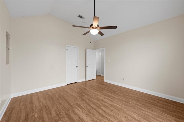 unfurnished bedroom with wood-type flooring, lofted ceiling, electric panel, and ceiling fan