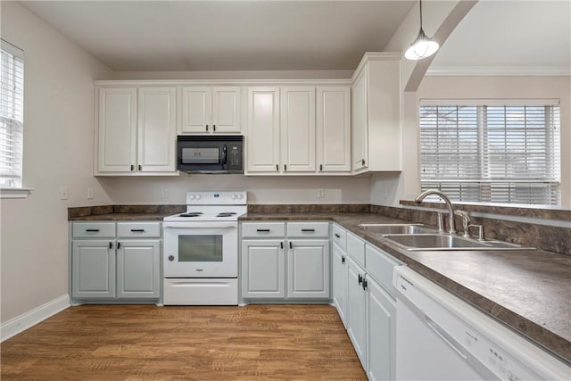 kitchen with sink, white appliances, light hardwood / wood-style flooring, and white cabinets