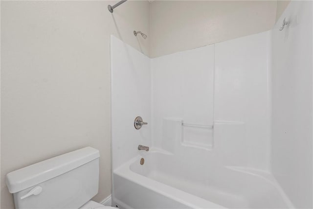 bathroom with bathing tub / shower combination and toilet