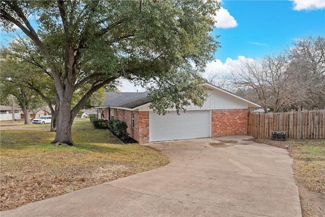 view of side of home with a garage and a lawn