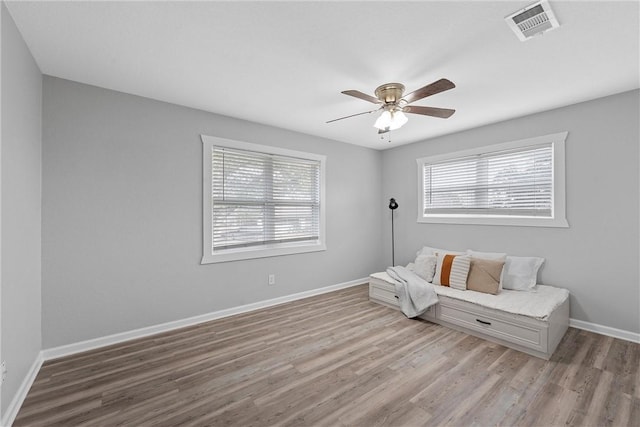 sitting room with ceiling fan, plenty of natural light, and light hardwood / wood-style flooring