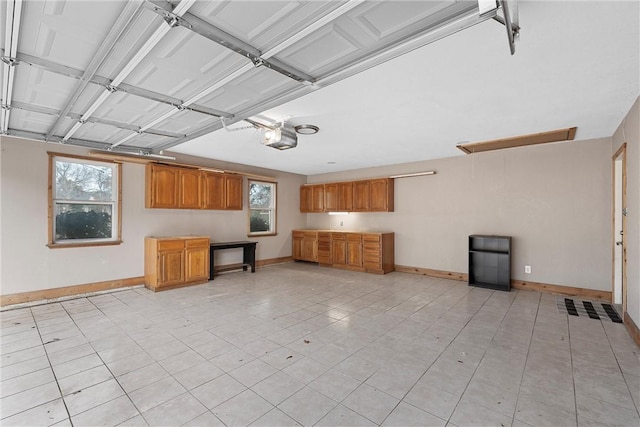 unfurnished living room with light tile patterned floors and a wealth of natural light