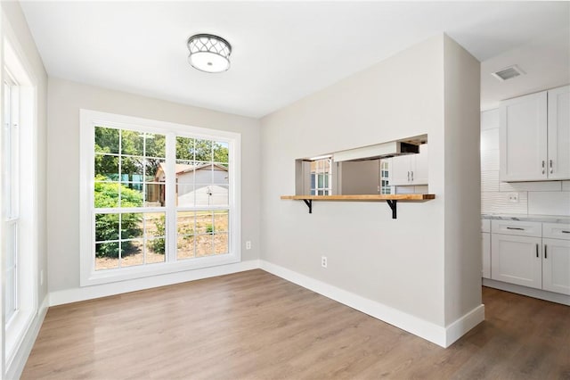 unfurnished dining area featuring hardwood / wood-style floors