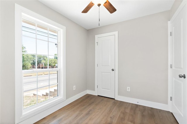 empty room featuring ceiling fan and hardwood / wood-style flooring